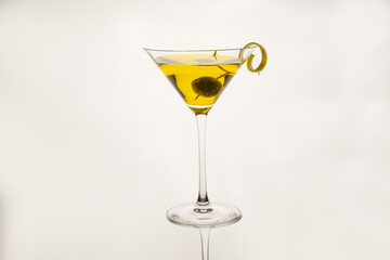 classic sidecar cocktail with a lemon twist isolated on a white background
