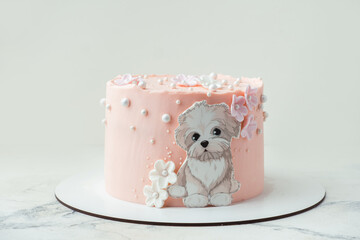 Birthday cake with pink cream cheese frosting decorated with cute dog shaped edible sugar paper....