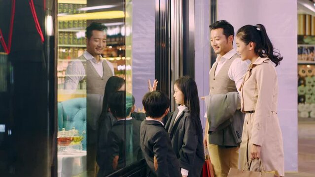 asian family with two children shopping in mall