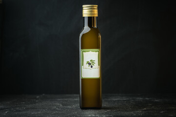 Glass bottle of cold pressed olive oil with golden cap on the black background. Copy space. Blank label with space for text on the bottle - Powered by Adobe