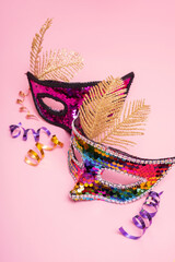 Festive face mask for carnival or masquerade celebration on colored background