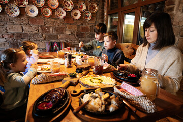 Family having a meal together in authentic ukrainian restaurant.