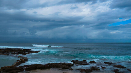 Tide pool at the Point, Mossel Bay under dark, threatening skies, Western Cape.