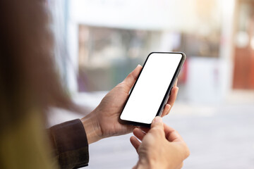 cell phone blank white screen mockup.hand holding texting using mobile on desk at office.background empty space for advertise.work people contact marketing business,technology
