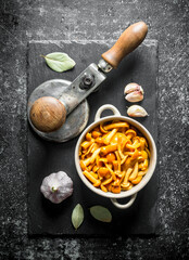 Pickled honey agaric on a stone Board with garlic and Bay leaf.