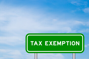 Green color transportation sign with word tax exemption on blue sky with white cloud background