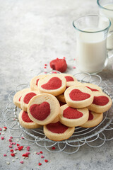 Valentines day cookies. Shortbread cookies inside a sweet red heart on pink plate on grey background. Mothers day. Womans day. Sweet holidays baking. Top view.