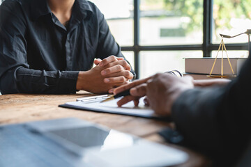 A young Asian lawyer or legal advisor clarifies information about business deals. The signing of...