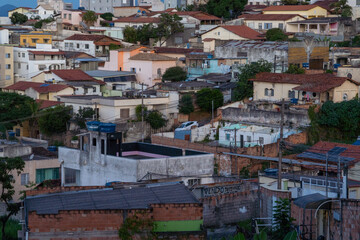 Amazing metropole with houses on small hills and horizon with mountains