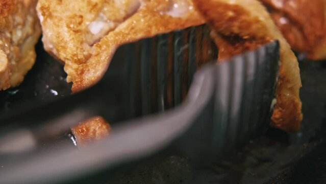 Close up footage of preparing chicken meat in frying pan.