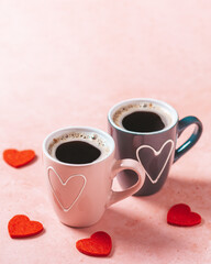 Two coffee cups with heart in pink and black colors for Valentines Day
