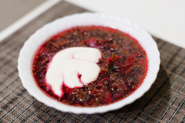 Borscht - sour soup common in Eastern Europe - made with red beetroots and sour cream - Shallow focus