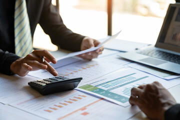 Fototapeta premium Financial analyst analysis business financial report on digital tablet during discussion at meeting of corporate showing the results of their successful teamwork., business meeting concept, Marketing