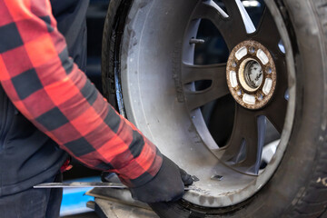 Process of wheel balancing at car service, transport concept