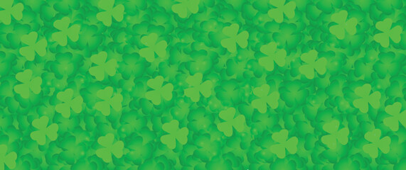 Many green shamrock leaves as background. St. Patrick's Day celebration