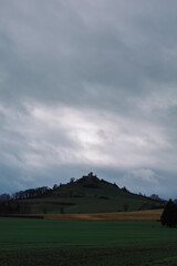 Fototapeta premium Hill with clouds and old castle ruins