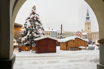 Pre-Christmas snowy square. View from the archway. Novy Jicin 2022. Czechia