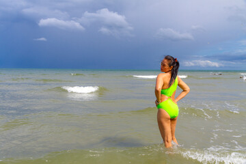 Woman with swimsuit relax on wave at beach