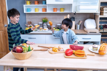 Children in learning kitchen room playing use fake bread and wooden cooking ware as sword fighting