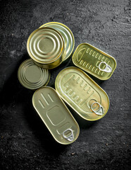 Various closed metal cans of canned food.