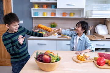 Children in learning kitchen room playing use fake bread and wooden cooking ware as sword fighting