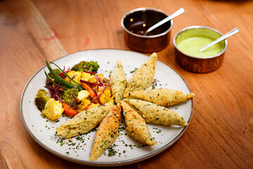 Indian food. Grilled vegetables and vegetarian rolls.
