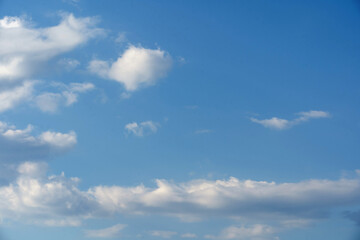 Blue sky and white clouds floated in the sky on a clear day with warm sunshine combined with cool breeze blowing against the body resulting in a miraculous refreshing like paradise.