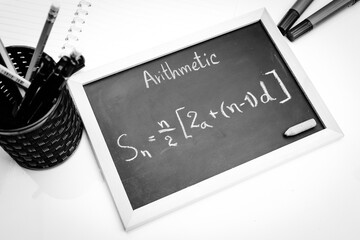 Blackboard with hand written Sequences and Series Formulas