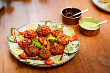 Fried mushrooms with mint and tomato sauces and vegetables.