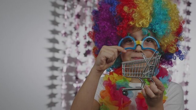 Boy of 10 years old dressed in clown's wig and eyeglasses. 