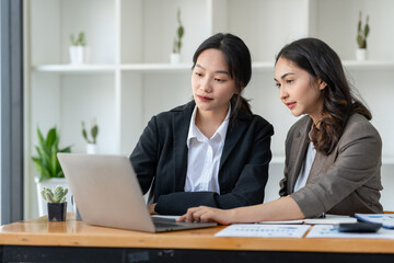Business idea creative brainstorming sessions for projects Strategic topic of two Asian girls working together data analysis Happy clarification of various financial information at the desk.