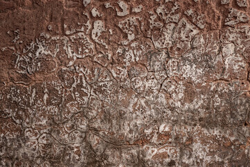 Dark brown ruined plaster wall with abstract crack texture