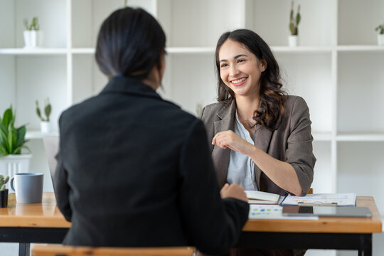 Business idea creative brainstorming sessions for projects Strategic topic of two Asian girls working together data analysis Happy clarification of various financial information at the desk.