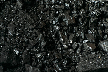 Black coal stones close-up. Solid advertising background..
