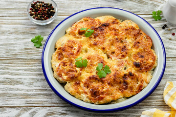 Vegetarian breakfast casserole on wooden background. Top view, copy space, flat lay.