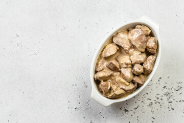 Chicken stroganoff in ceramic dish. Top view, copy space, flat lay.