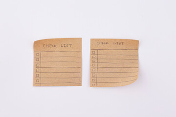 hand draw checklist on note taped recycle paper