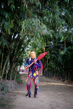 Hindu religious village people celebrating gajan festival wearing colourful costumes