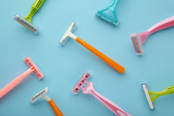 Many women razors on the blue background