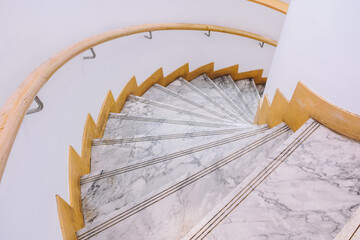 Marble spiral staircase with wooden holding handrail, down stair to the secret room on the ground floor