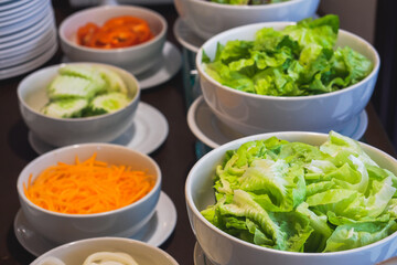 Selective focus on fresh cabbage in white bowl with anothers blur background as salad bar buffet self service as famous appetizer for diet in the restaurant and hotel