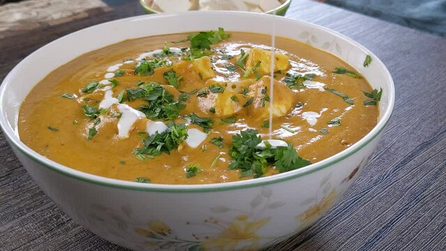 Paneer butter masala garnishing with heavy whipping cream home made Indian masala recipe.  This paneer masala curry gives best taste with Biryani / Roti/ Naan 