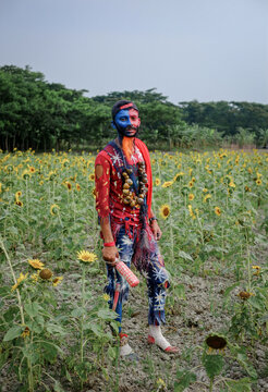 Hindu religious village people celebrating gajan festival wearing colourful costumes