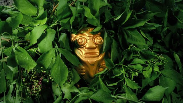 Golden Idol In The Jungle With Plants Moving In Breeze