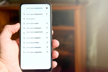 Male hand holding mobile phone screen with search 