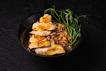 Thai Chicken Fried Rice or Kao Pad Sapparod on a black plate on black concrete background