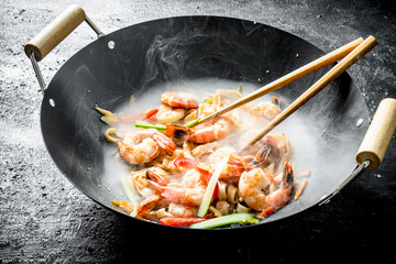 Hot Chinese wok Udon noodles with sauce, shrimp and vegetables.