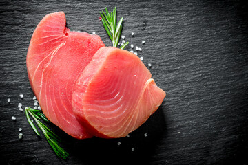 Fresh raw tuna steak with rosemary.