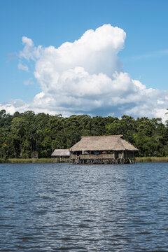 Picturesque and exotic lagoon with clean water El Milagro, loggon milagros with wooden house and thatched roof stilt houses Amazon jungle Tingo Maria Peru-Oct 2020