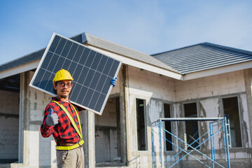 Technician holding solar panels to install on the roof of the house